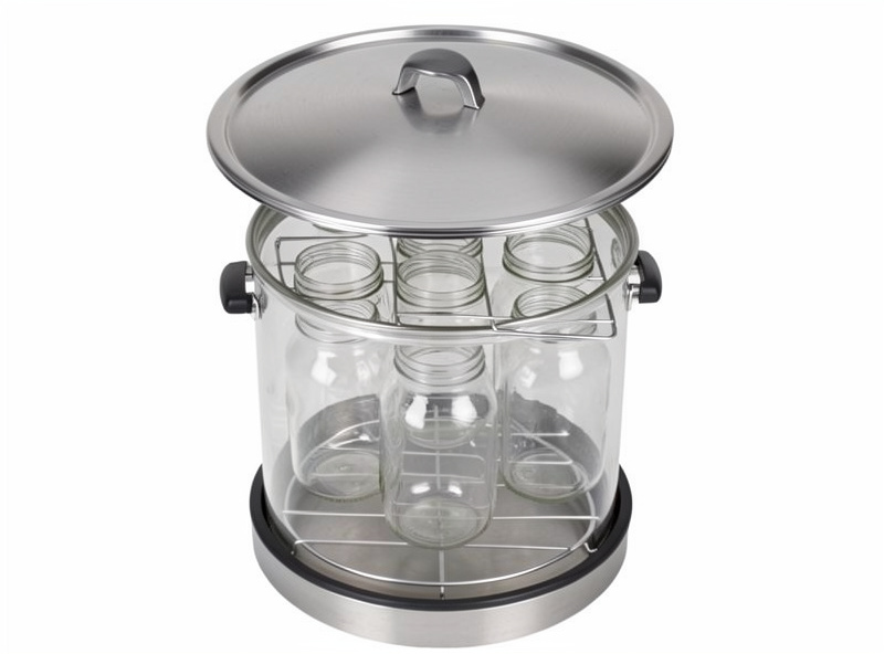 Tall stovetop pressure canner with the lid off showing a rack of quart jars